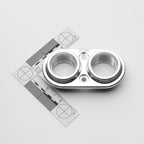 Metallic mechanical component with a ruler for scale on a light gray background