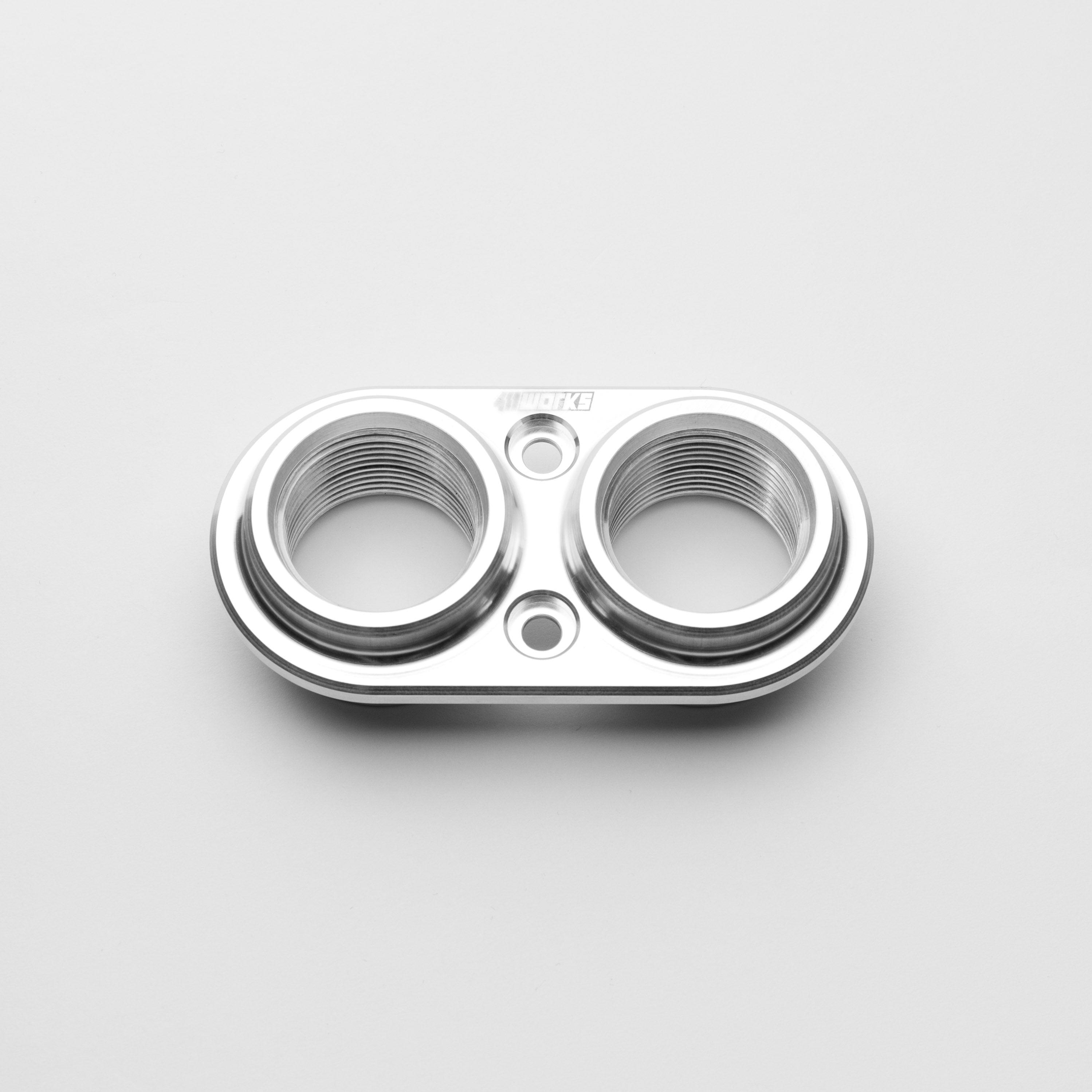 Metallic bulkhead with two cylindrical holes on a light gray background