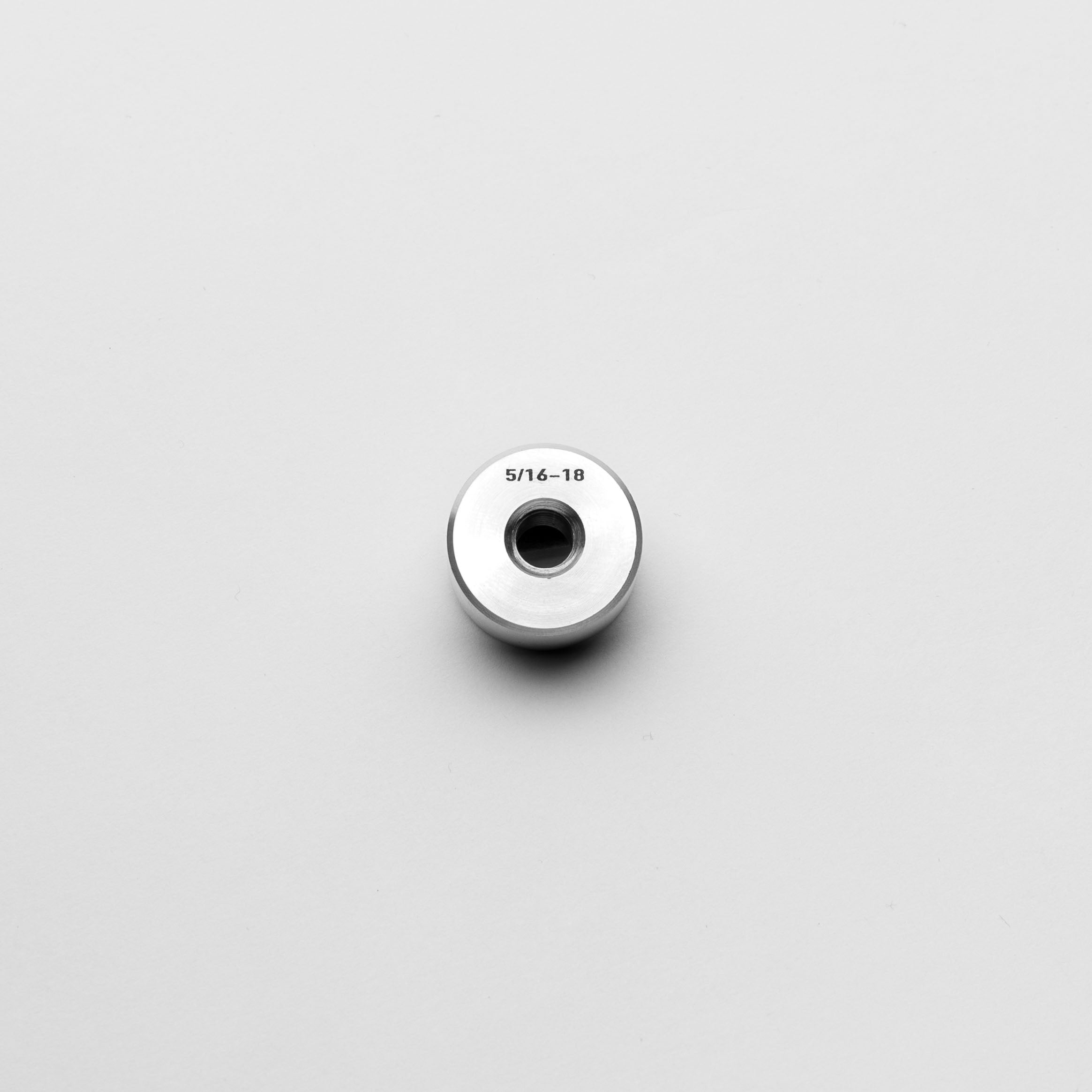 Metallic thread bung with measurement '5/16-18' on a light gray background