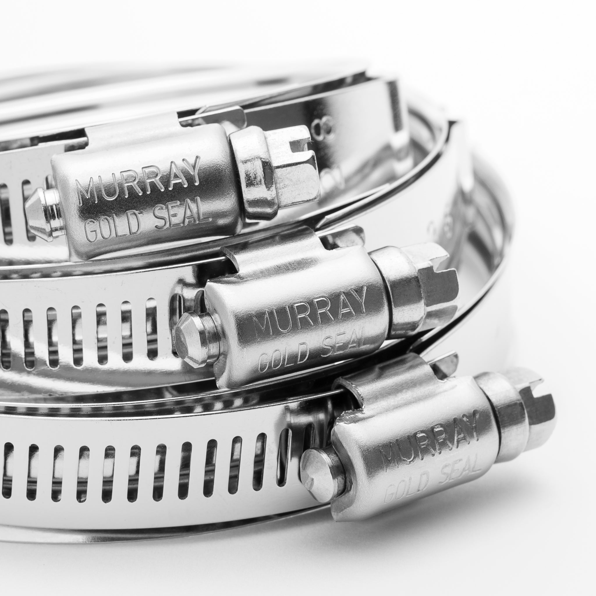 Close-up of metal MURRAY Gold Seal labels on a white background