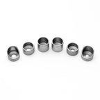 Set of six metallic cylindrical components on a white background