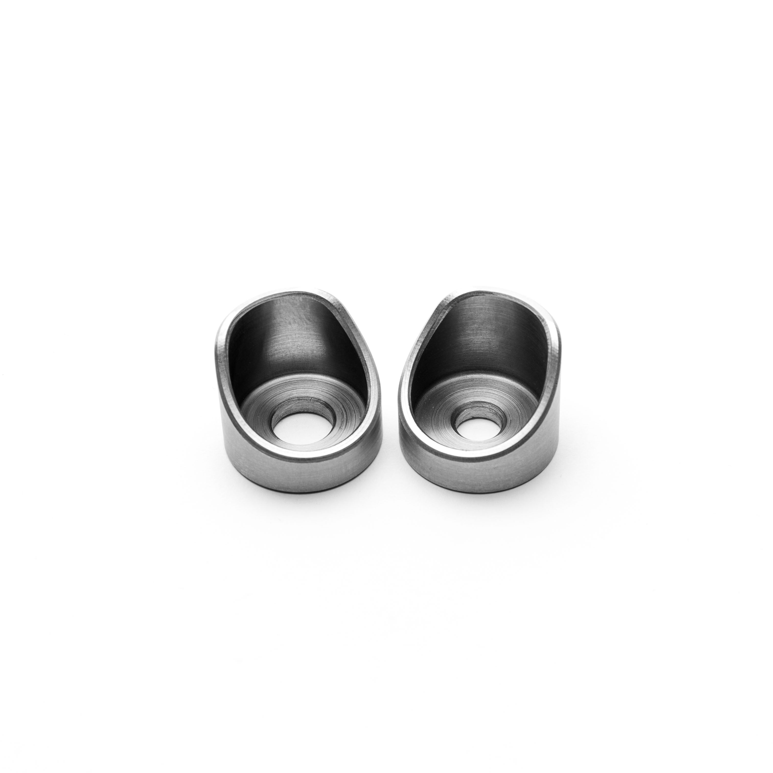 Two metallic weld cups on a white background