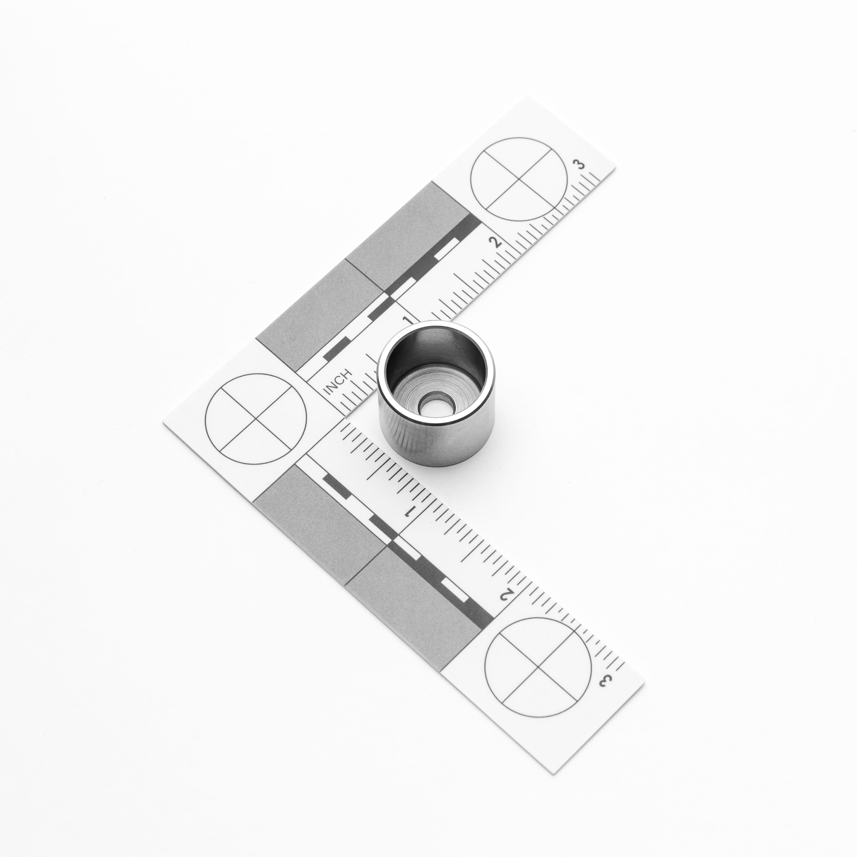 Metal measuring tool with a small M6 weld cup object on a white background