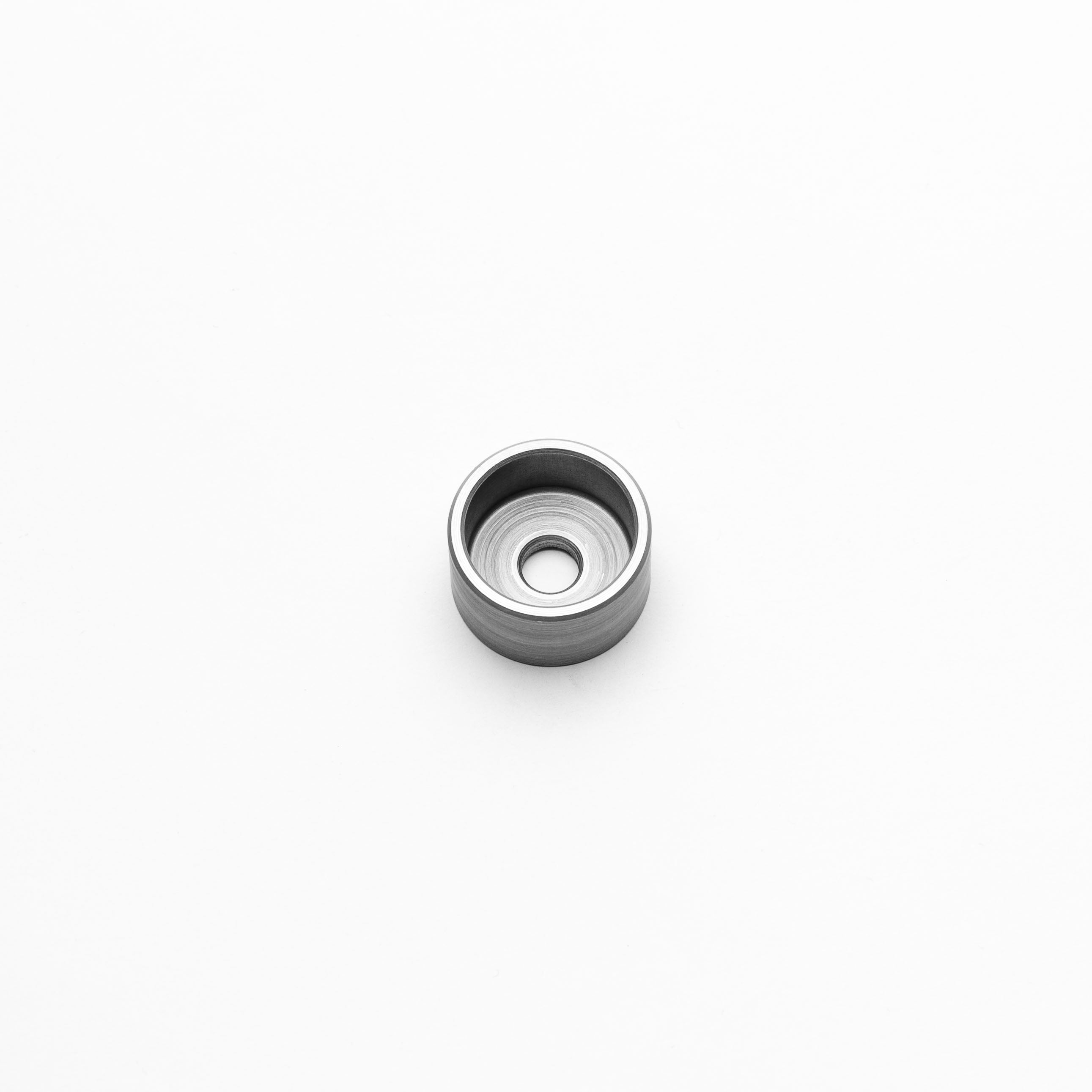 Metallic M6 shallow weld cup on a white background