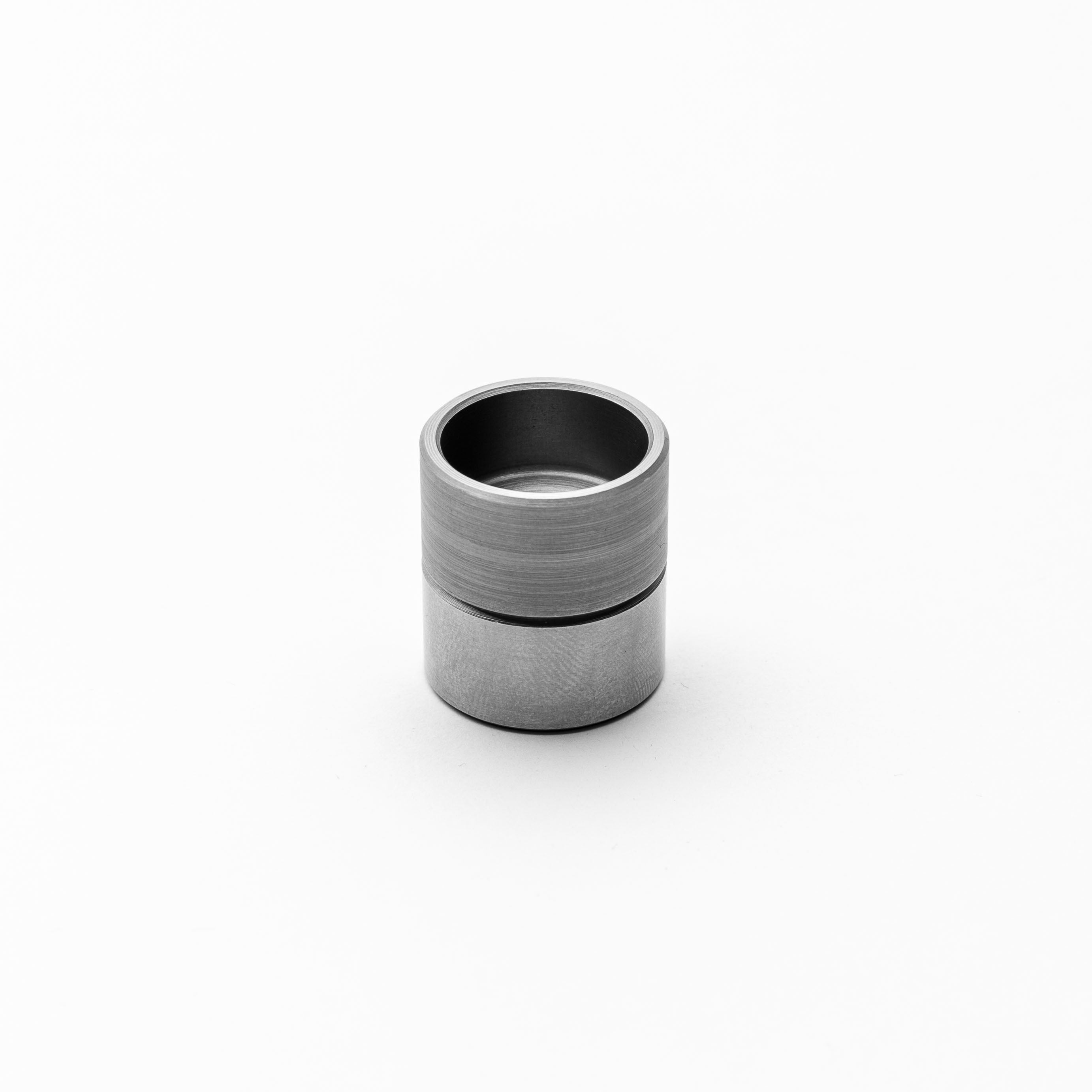 Metallic threaded bungs on a white background