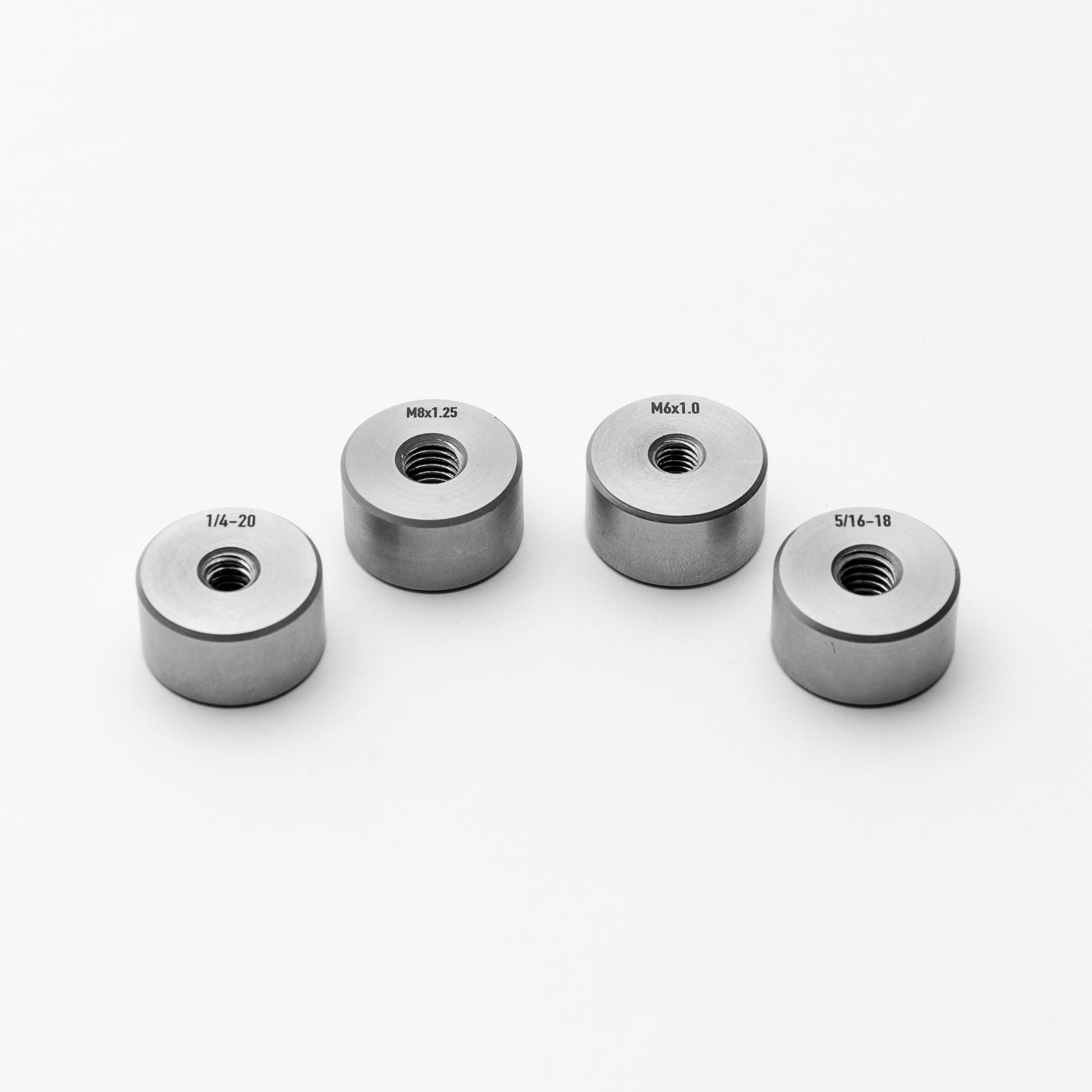 Threaded bungs with different thread sizes on a white background