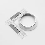 Silver ring with a ruler for size measurement on a white background