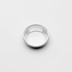 Small metallic reducer on a light gray background