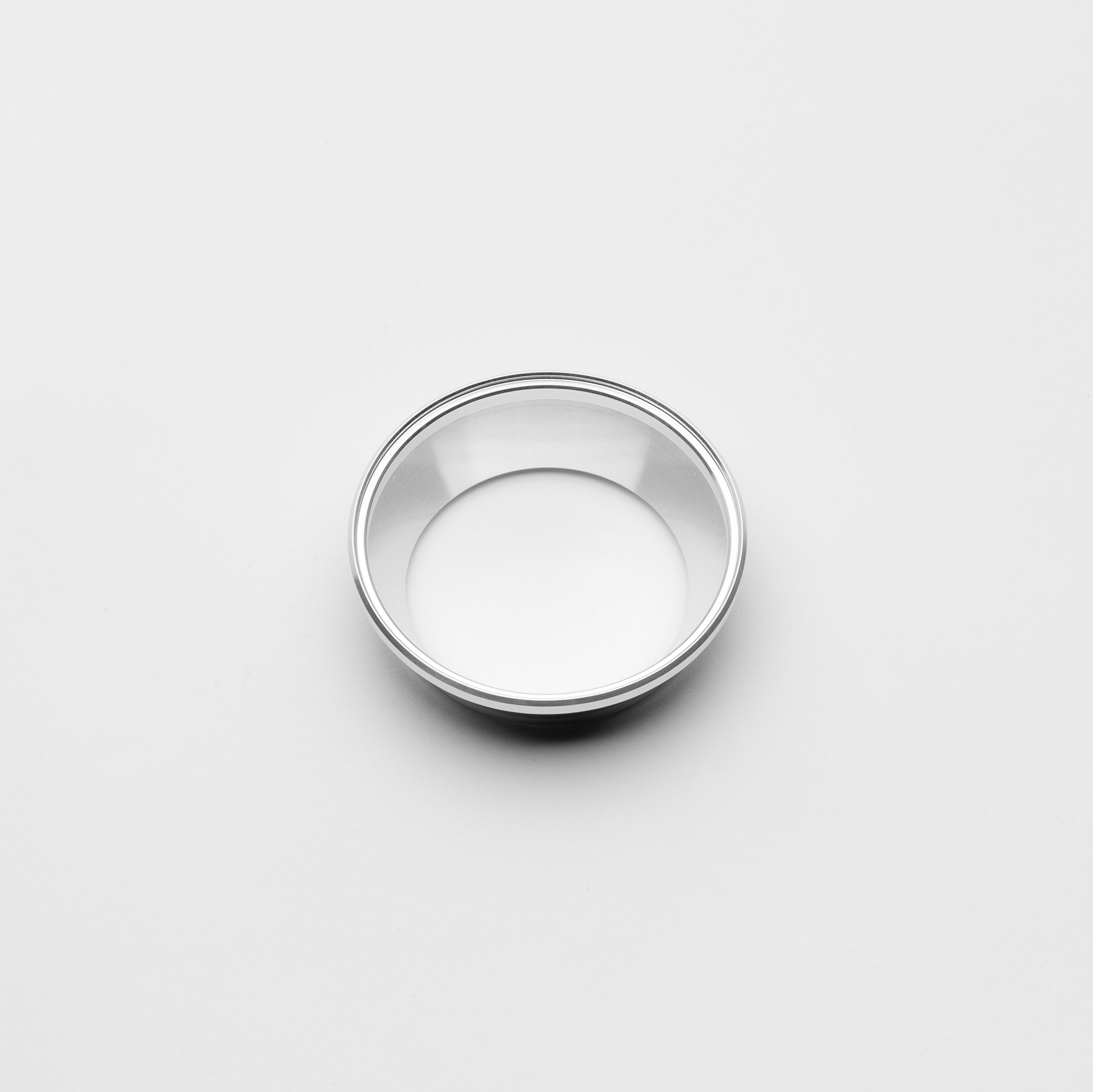 Small metallic reducer on a light gray background