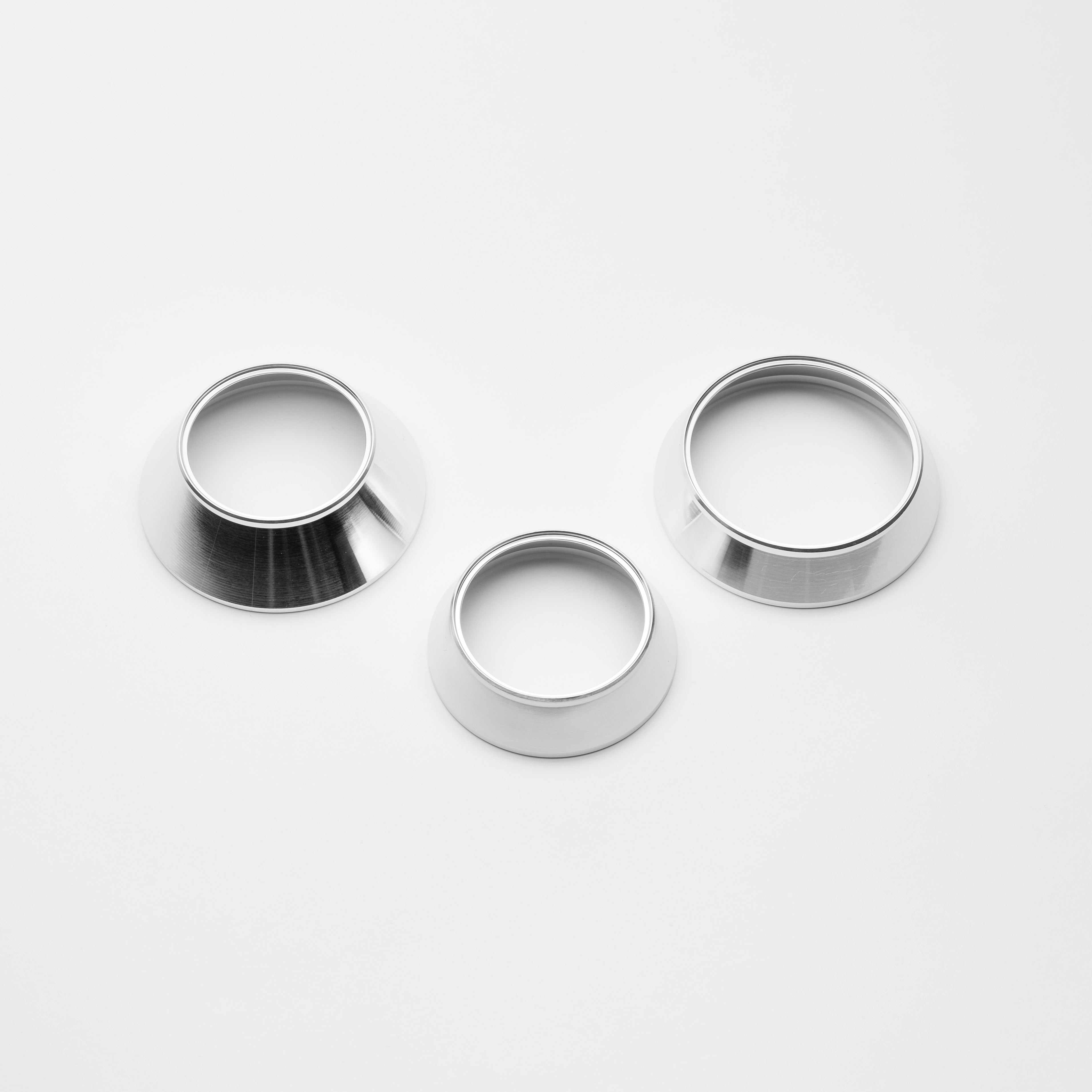 Three metallic rings of different sizes on a white background
