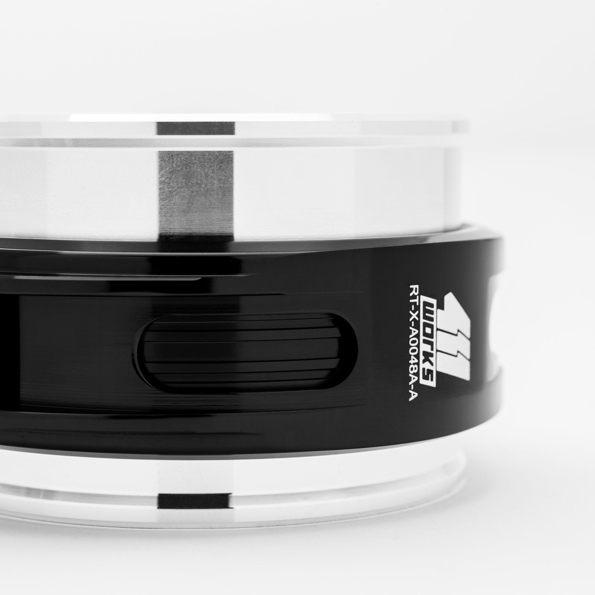 Close-up of a black and white cylindrical device with a brand logo on a light gray background