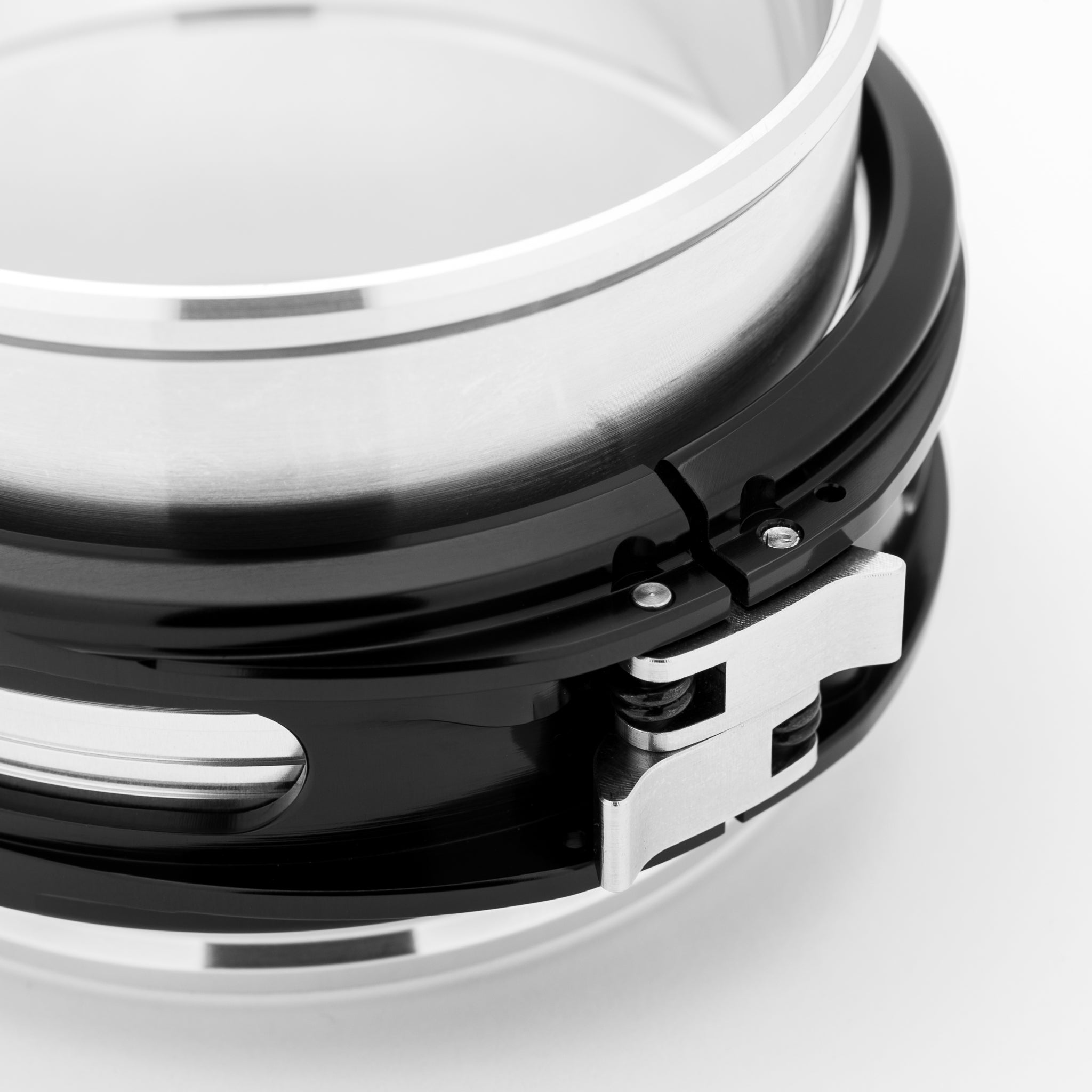 Close-up of a metallic clamp on a white background