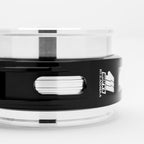 Close-up of a black and clear container with a brand logo on a white background