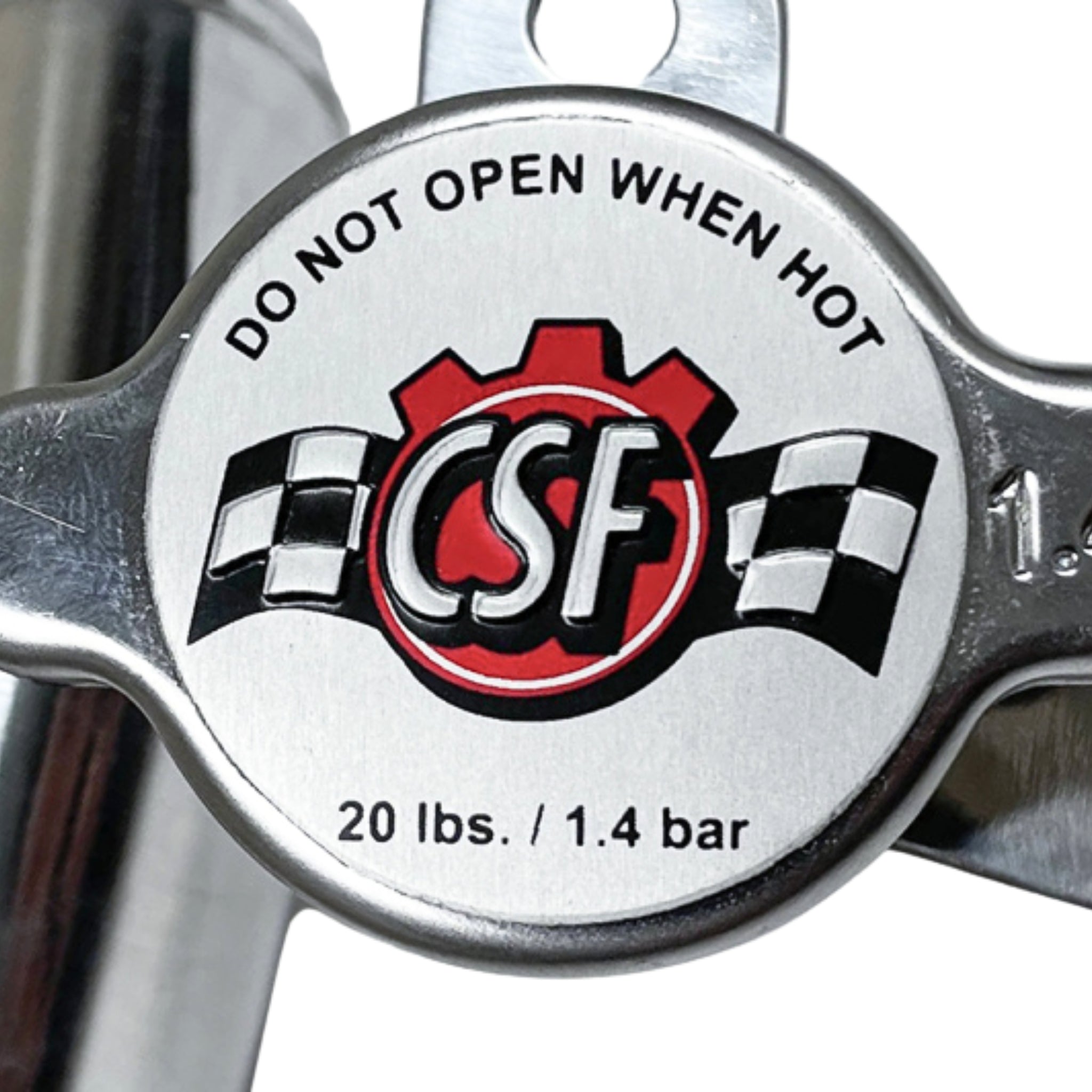 Metallic valve cap with 'CSF' logo and safety instructions on a white background