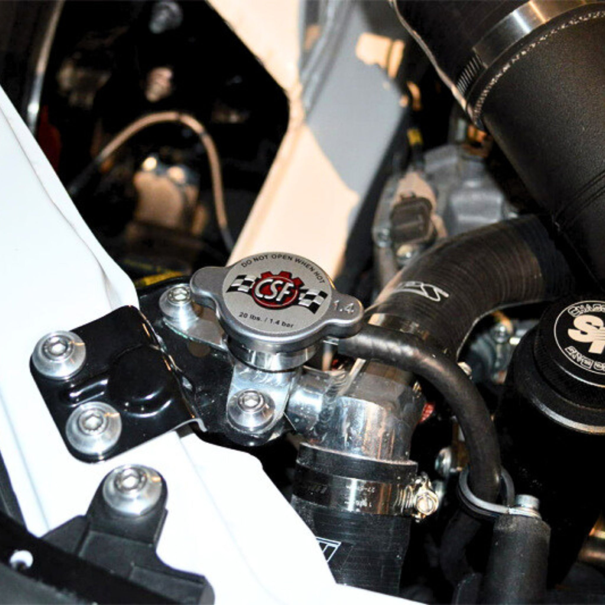 Close-up of a car Toyota GR86 engine with 'CSF' branded components.