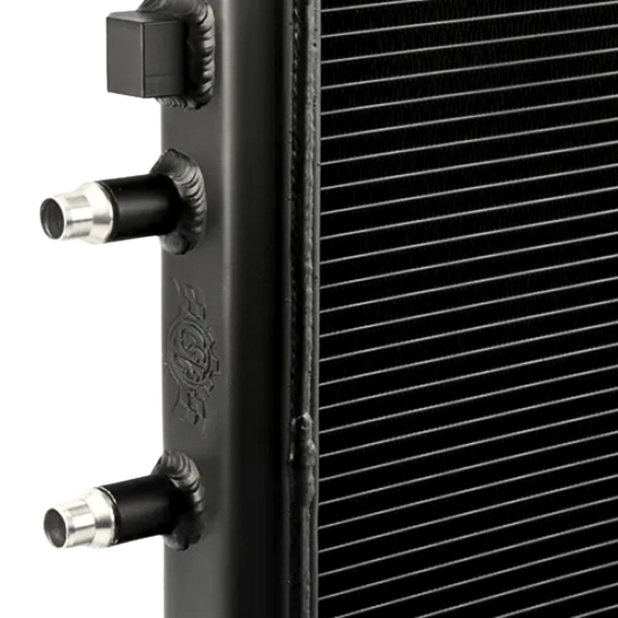 Close-up of a black radiator with metallic connectors on a white background