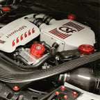 Car engine with 'CSF' and 'M Power' branding on a carbon fiber background