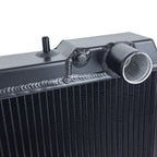 Close-up of a black radiator with metallic components on a white background