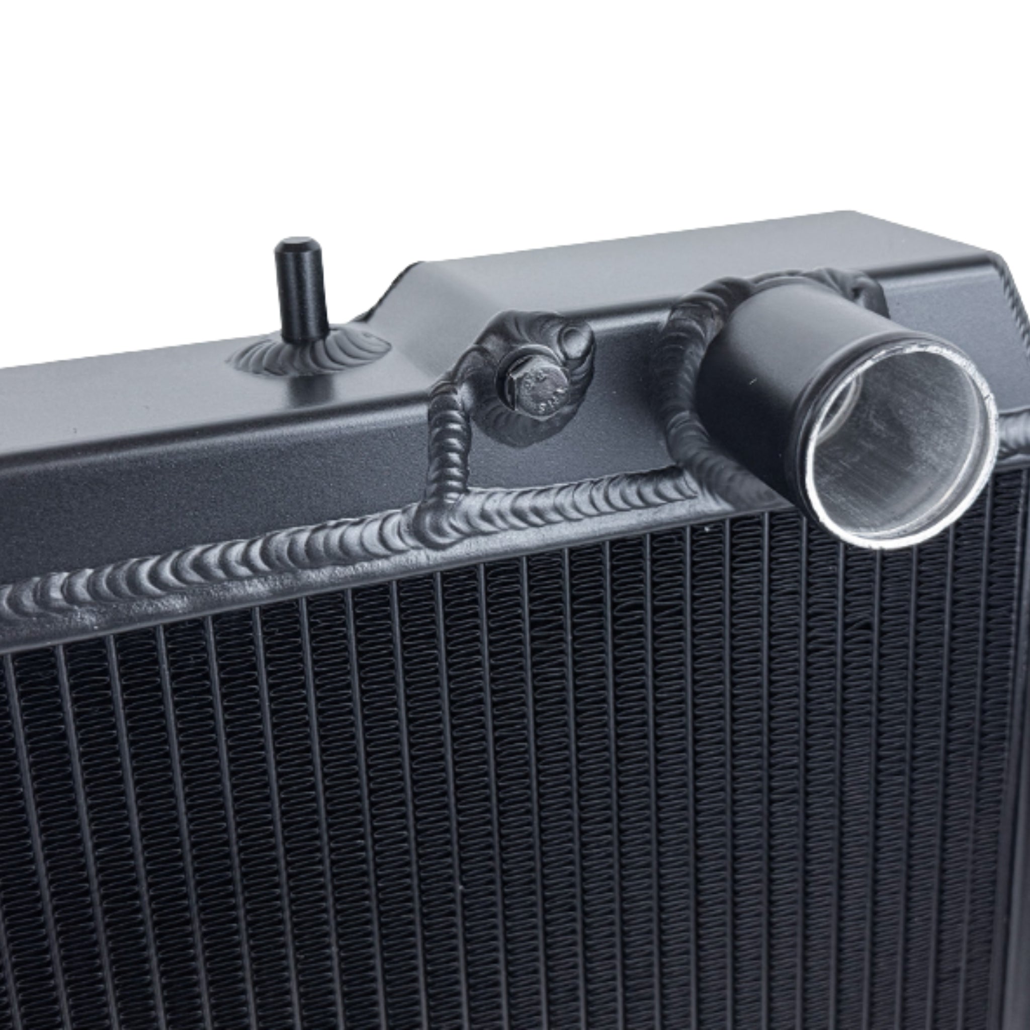 Close-up of a black radiator with metallic components on a white background