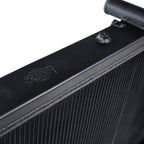 Close-up of a black radiator with a brand logo on a white background