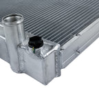 Metallic radiator with pipes and connectors on a white background