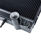 Close-up of a black radiator with metallic components on a white background