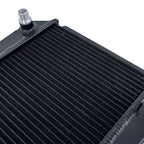 Close-up of a black radiator with a silver fitting on a white background