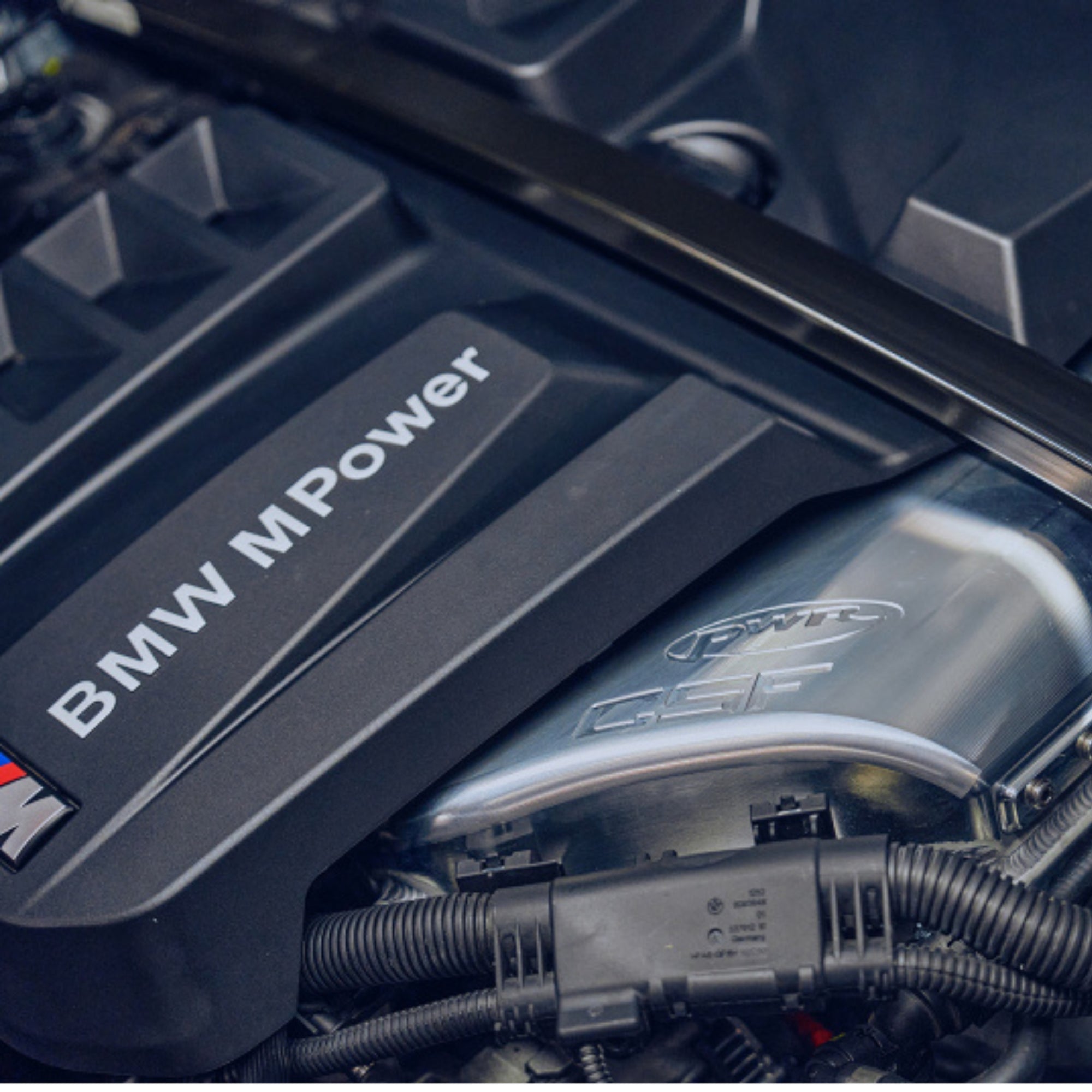 Close-up of a BMW M Power engine with visible branding.
