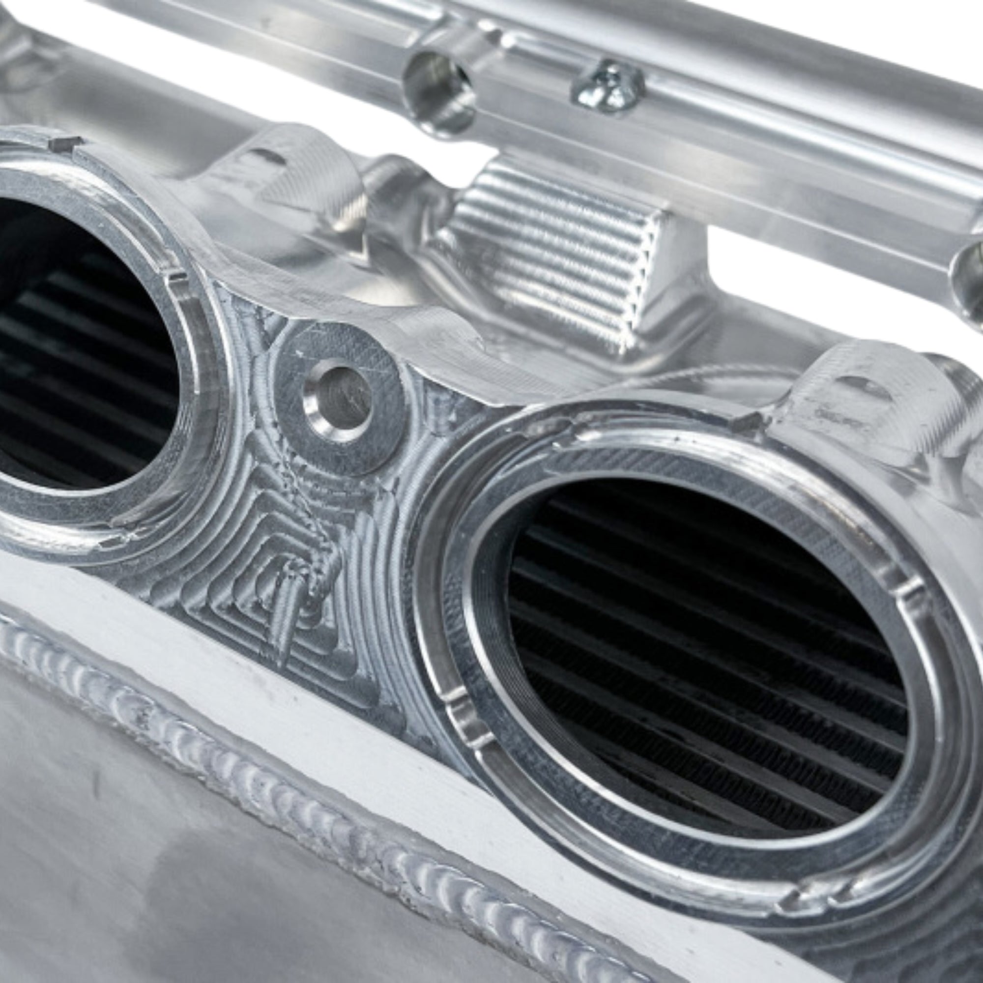 CSF Race X Gen 2 charge air cooler manifold in raw billet aluminum finish – superior heat dissipation for BMW turbo platforms
