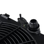 Close-up of a black radiator with visible branding on a white background