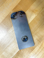 Metal plate with holes on a wooden floor