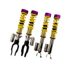 KW Nissan Set of four shock absorbers with purple and yellow springs on a white background