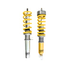 Porsche Ohlins Two yellow shock absorbers on a white background