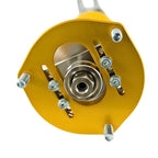 Close-up of a mechanical component with a yellow housing and metallic parts on a white background
