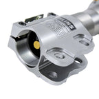 Close-up of a metallic mechanical component with 'Ohlins' branding on a white background