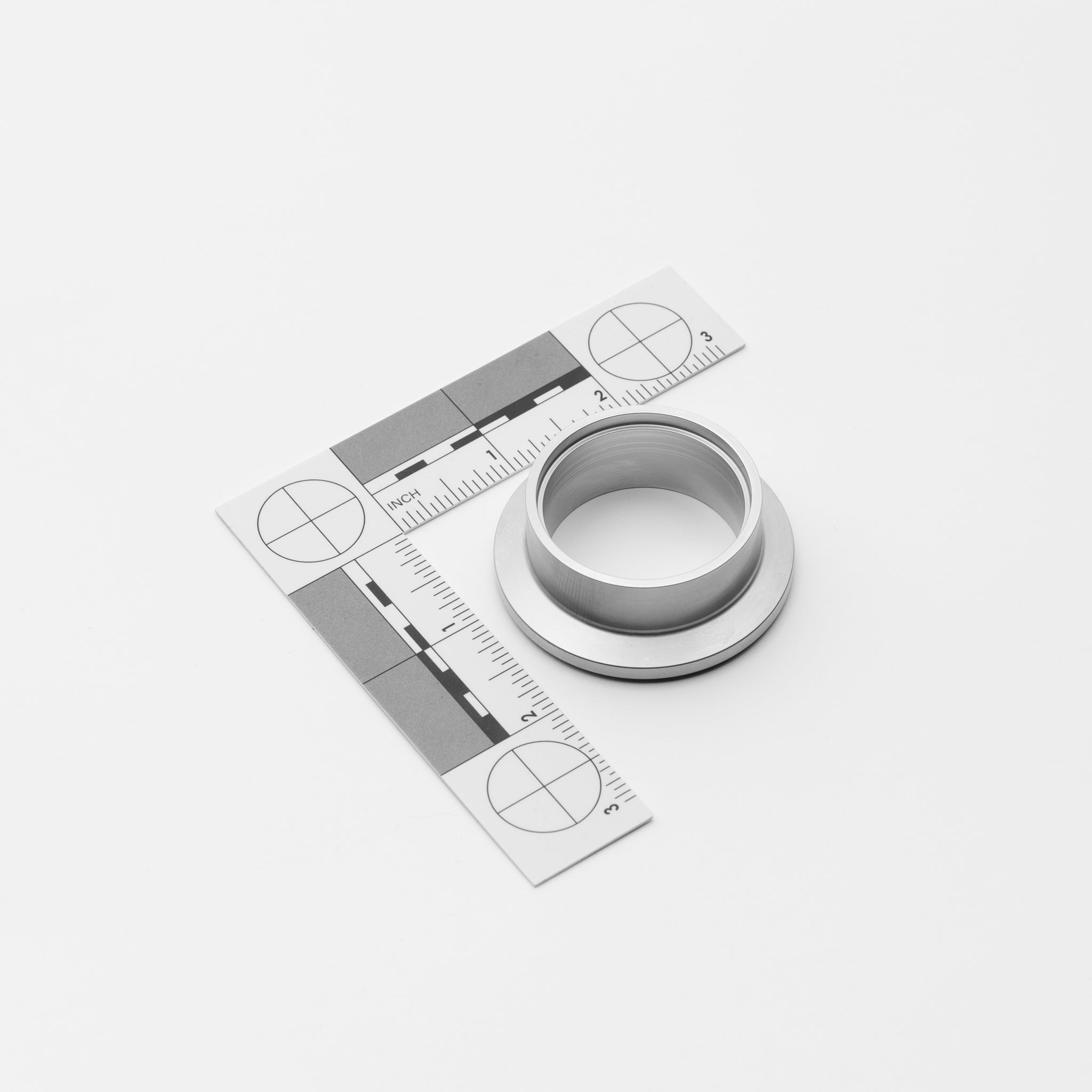 Metal V-Band Ferrule Male with a ruler for measurement on a white background