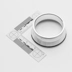 Metallic ring with a ruler for scale on a white background