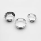 Three metallic bowls on a white background