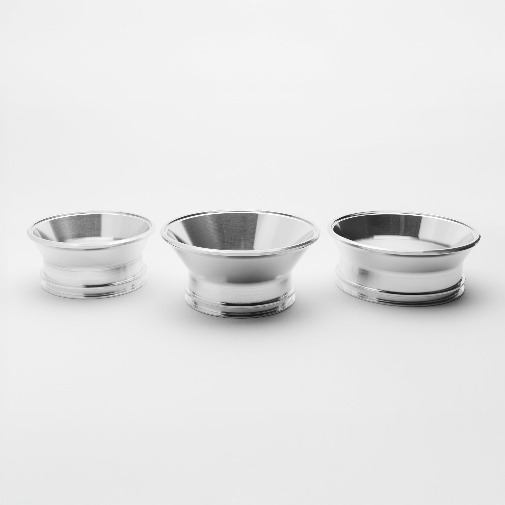 Three silver reducers of varying sizes on a white background