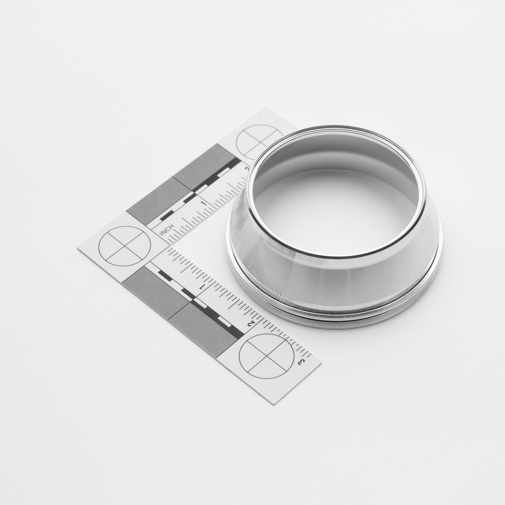 Metallic transition cylindrical object with a circular opening on a white background
