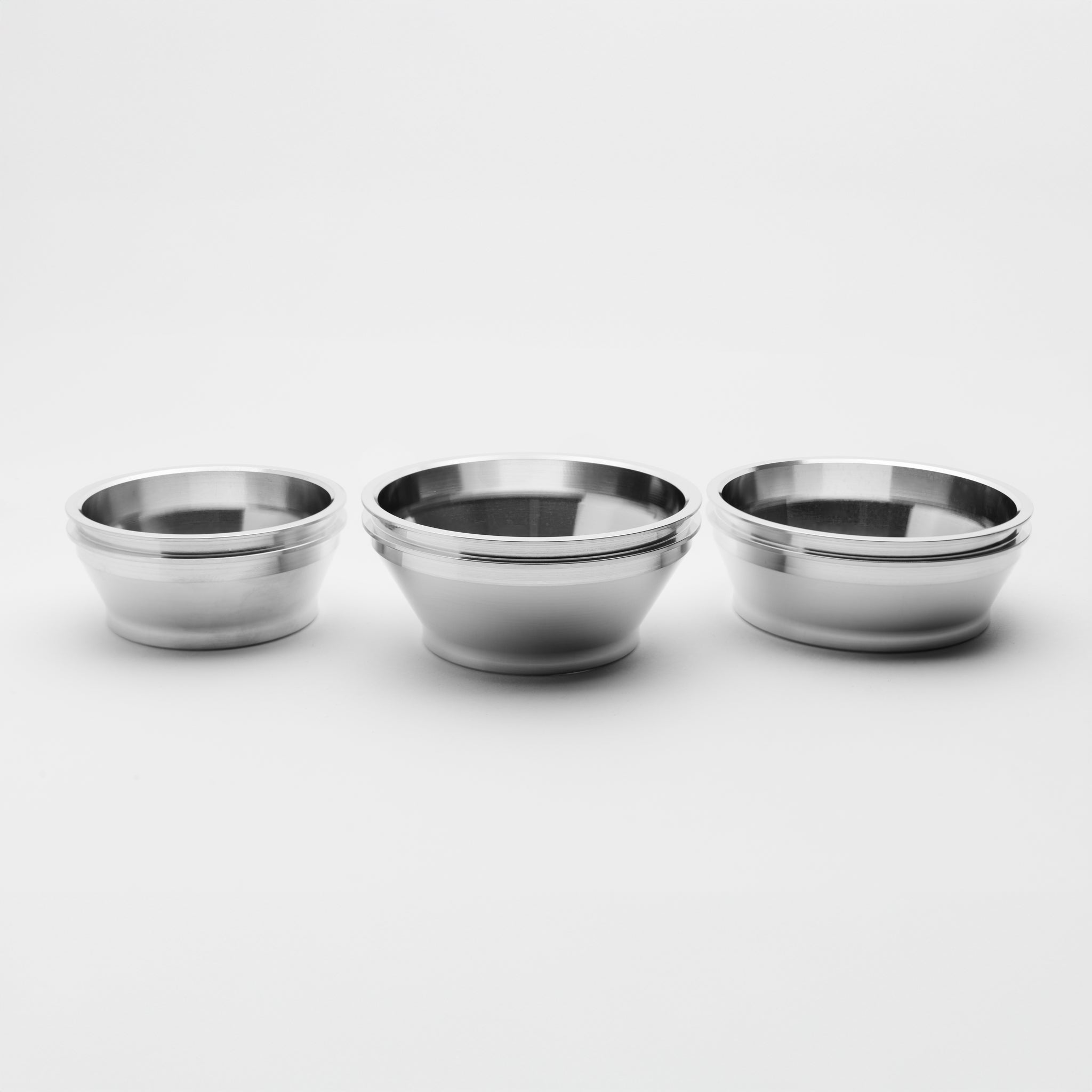 Three metallic reducer of different sizes on a white background