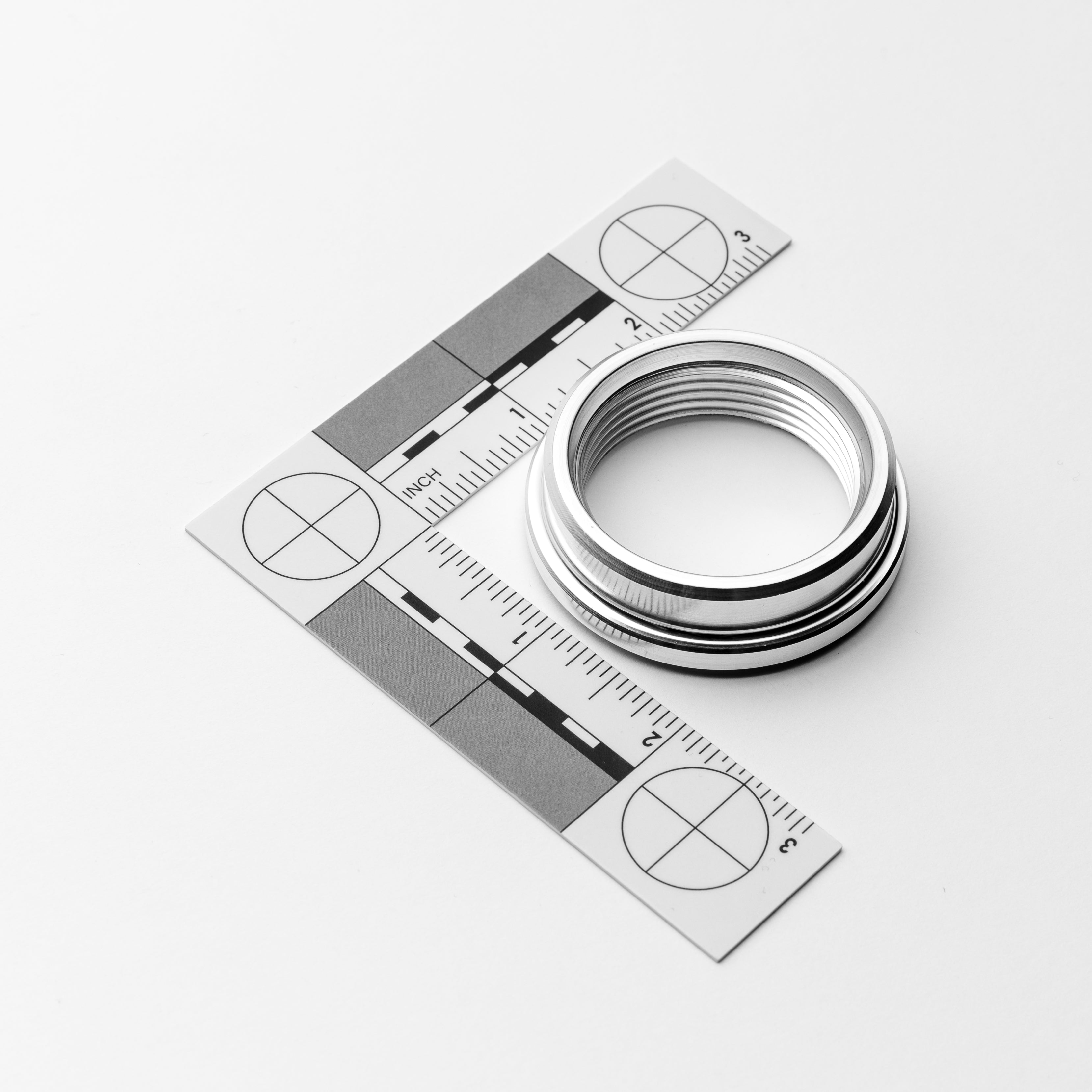 Weld on metal piece with ruler on a white background