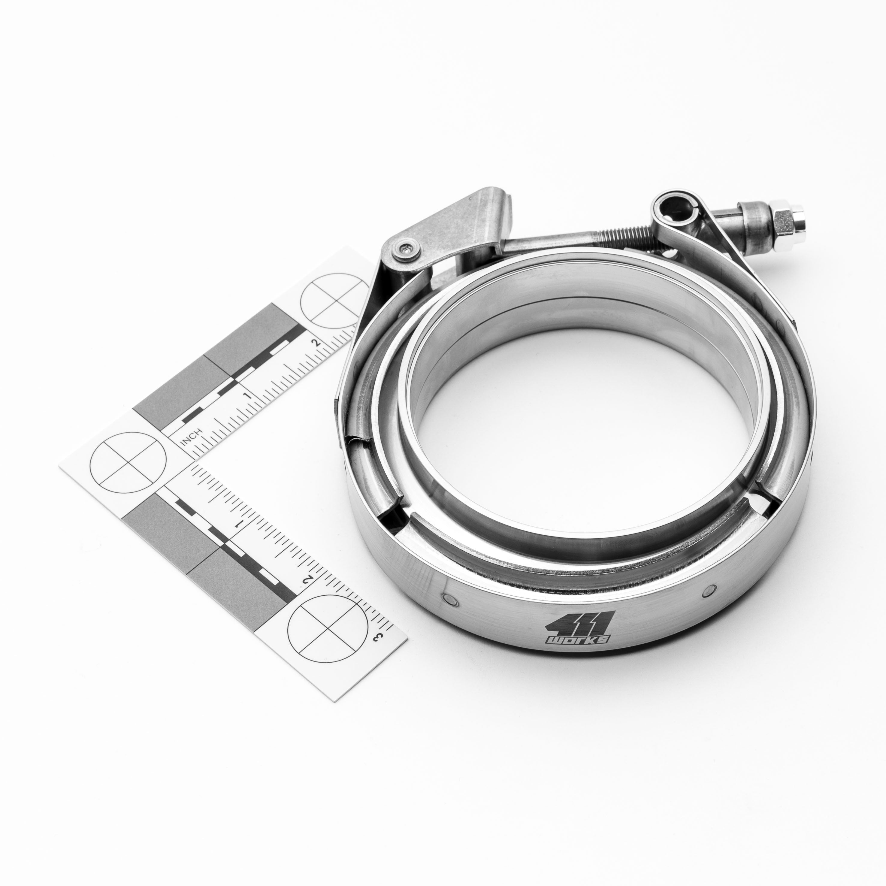 Metallic clamp with a ruler for scale on a white background