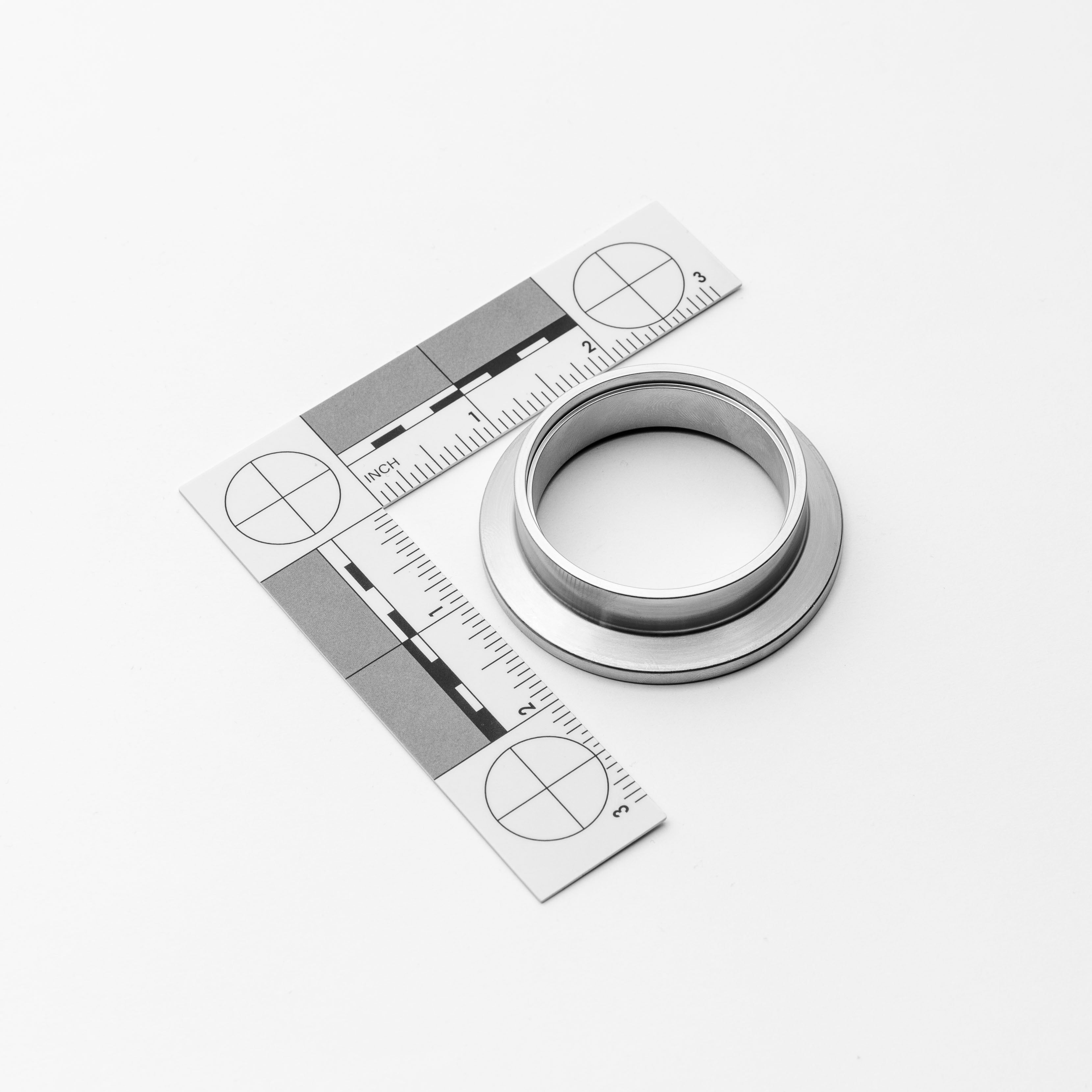 Metal ring with a ruler for measurement on a white background