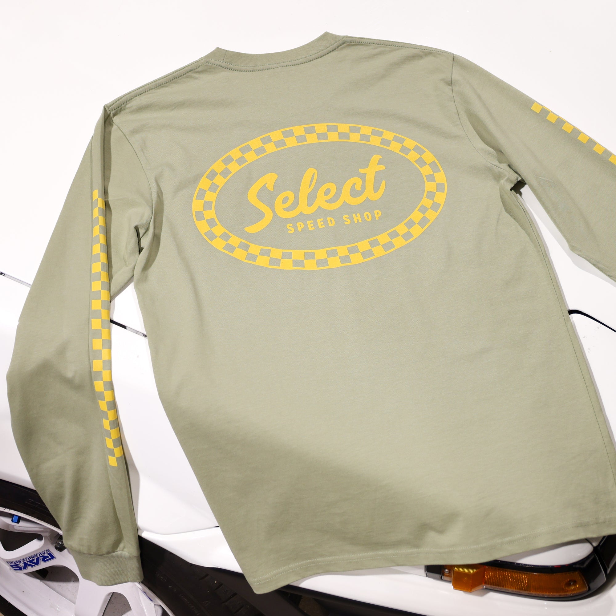 Green long-sleeve shirt with 'Select Speed Shop' logo on a white background